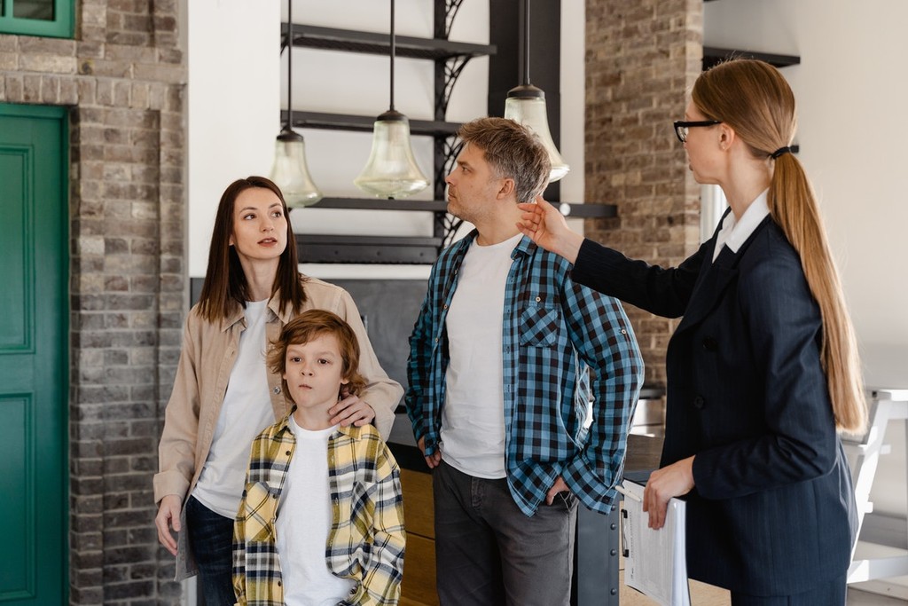 an agent showing a home to a potential tenant family