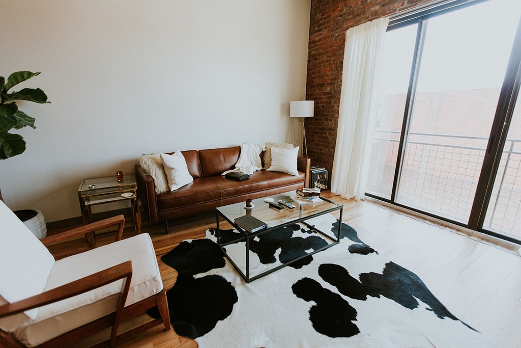 modern style living room with white furnishings and a sliding door