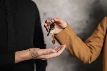 property manager hands keys to tenant