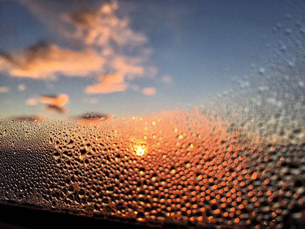 Window condensation against the sunset and clouds 