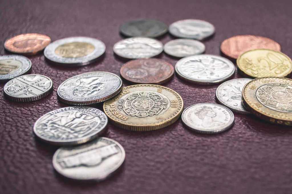 pile of UK coins laid out on leather