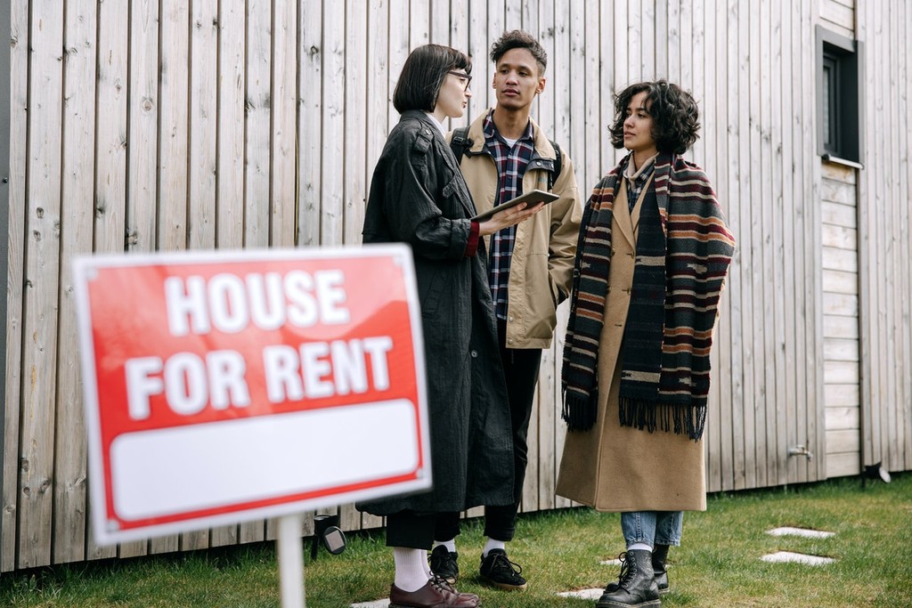 an agent showing a house to prospective tenants