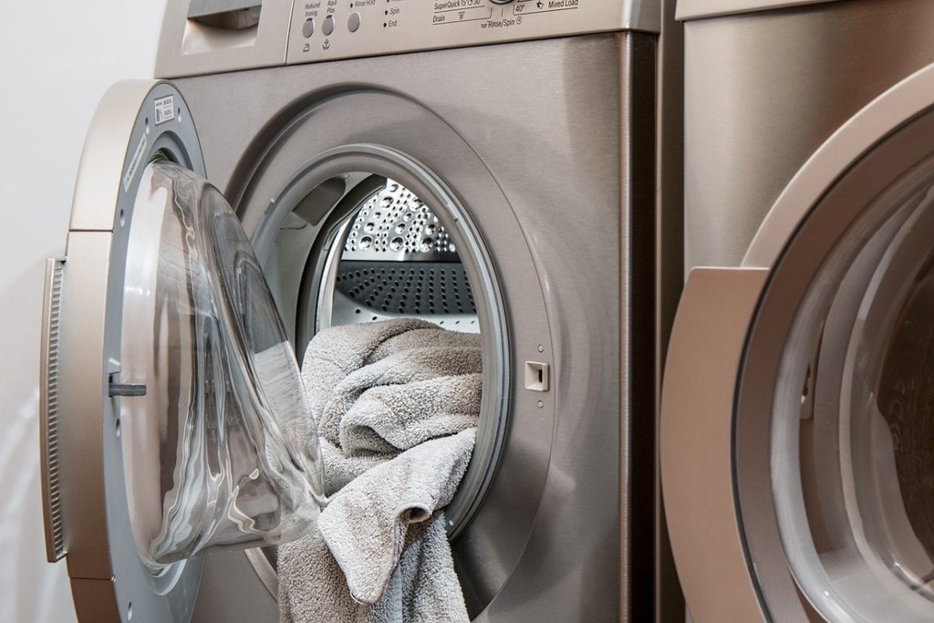 washing machine with the door open and towel inside