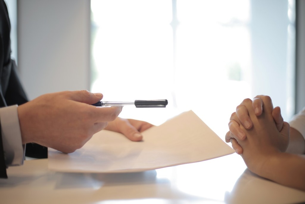 people signing a document