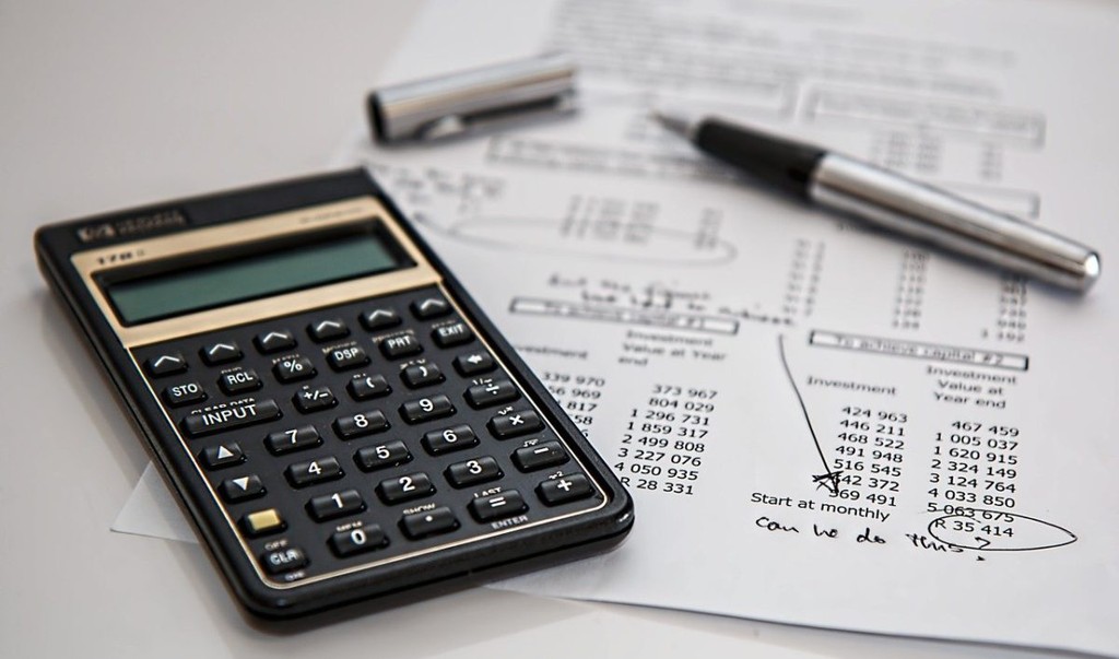 a calculator and an invoice lying on a table