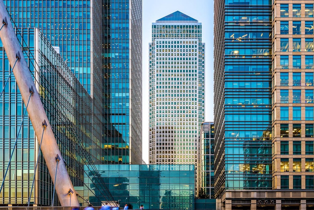 One Canada Square in canary wharf, London. Lots of glas high rise office buildings on a clear day