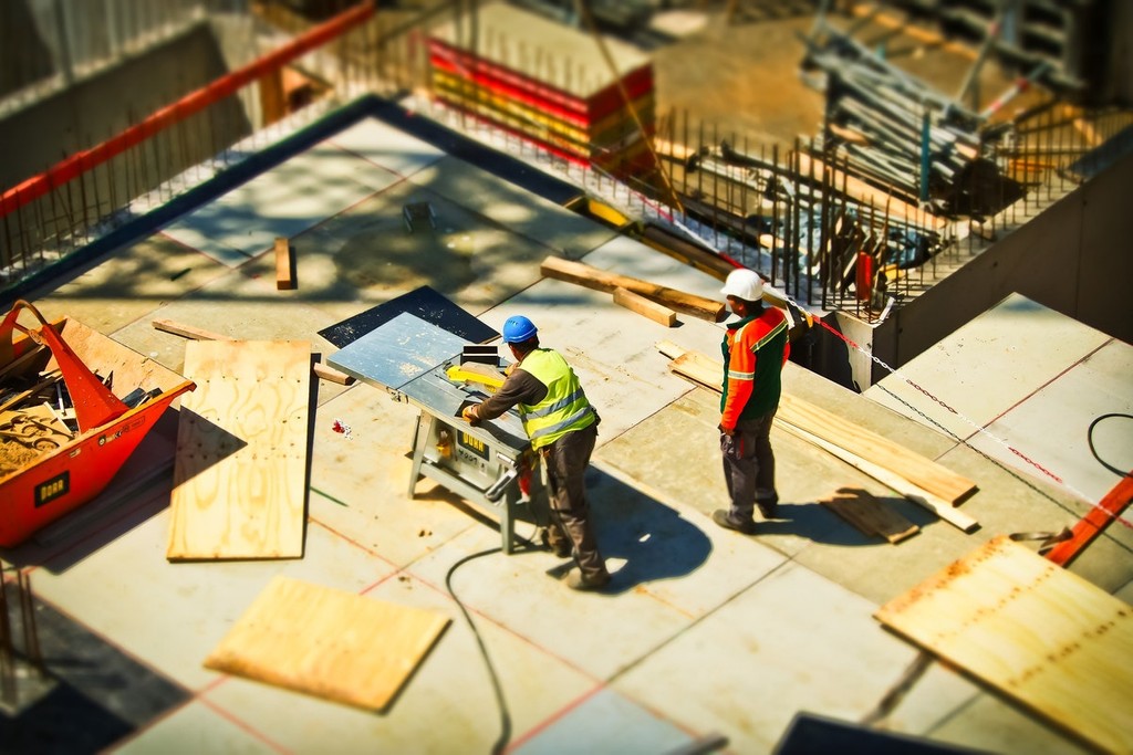 model of builders working on a site