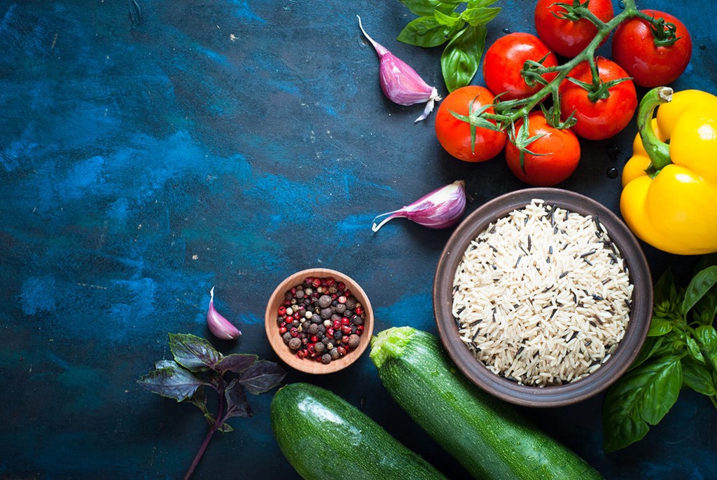 Ingredients for cooking - rice, vegetables and herbs. Top view with copyspace. Organic food background.