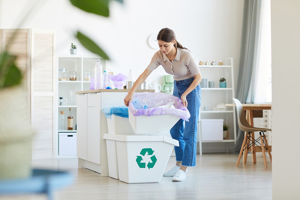 tenant taking out the recycling in her home