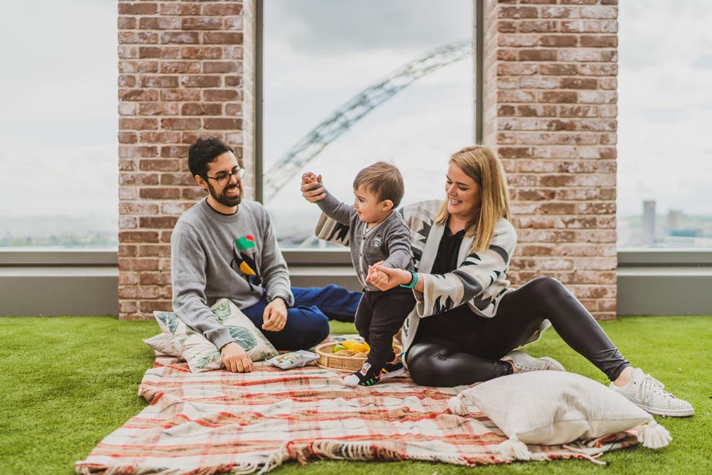 Loide and Joao Azinheiro on a communal terrace at Canada Gardens with their baby son, Benjamin.