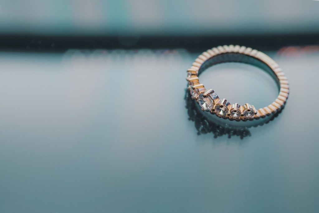 A silver and gold ring encrusted with diamonds.