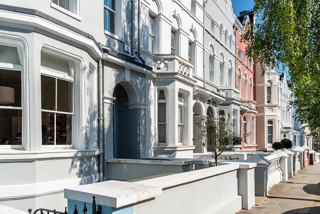 Colourful English Victorian Houses in Notting Hill, a district in West London in the Borough of Kensington and Chelsea