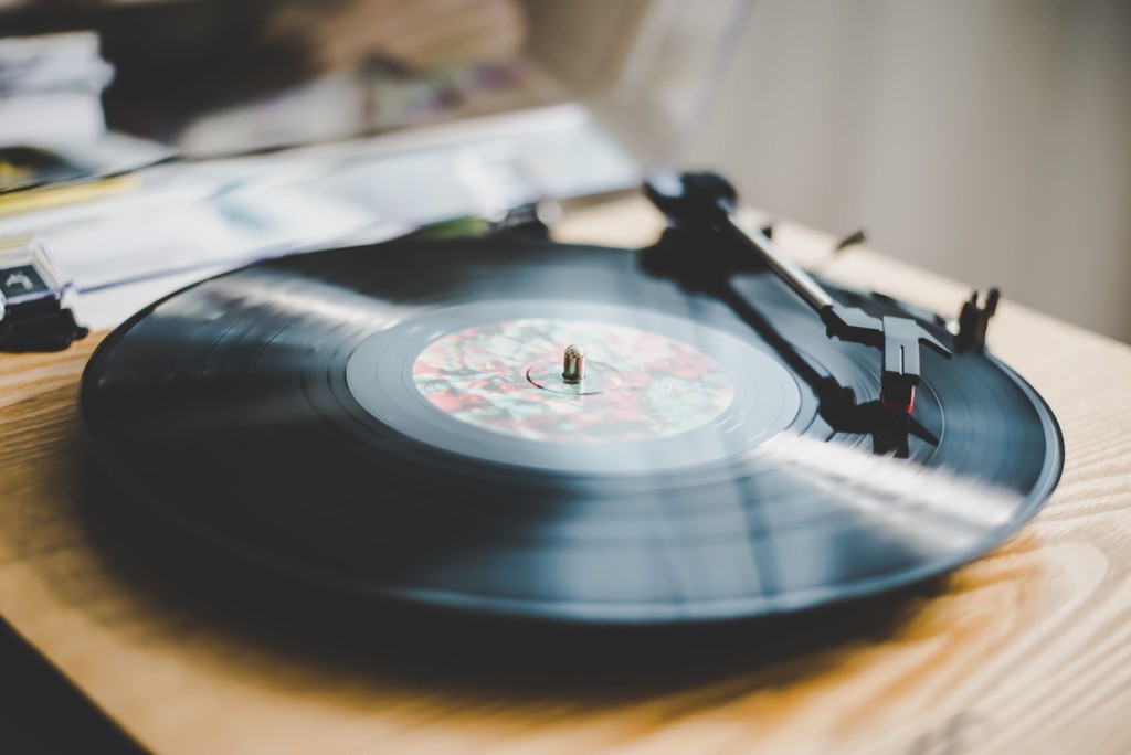 vinyl record plays on wooden table