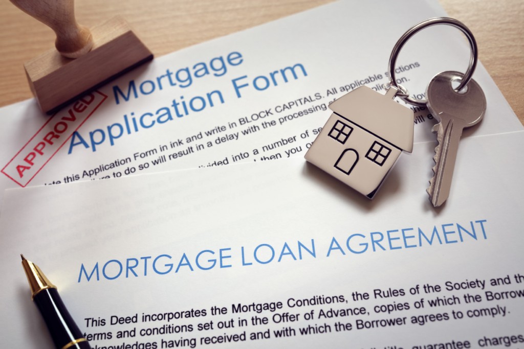 Mortgage application loan agreement and house key for unconventional home