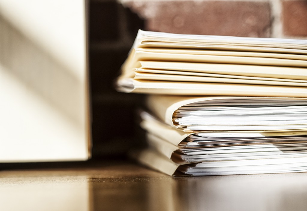 Close-up of files and file folders on a desk top in an office.