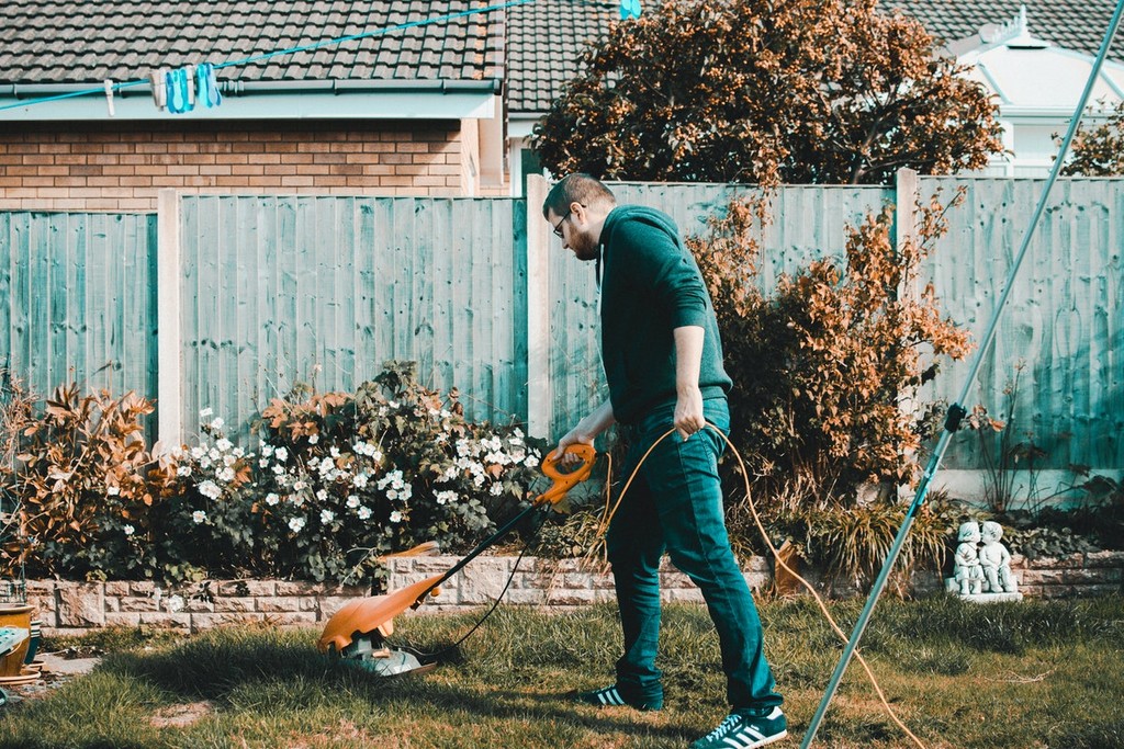 man cutting the grass in the garden