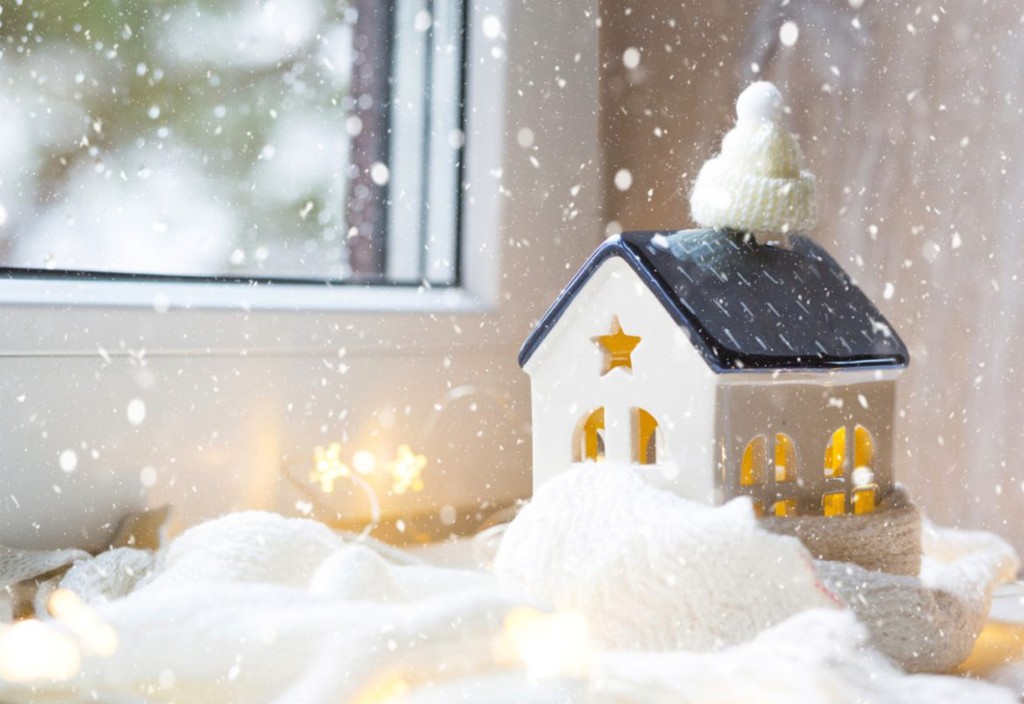 model house by window sill covered in snow