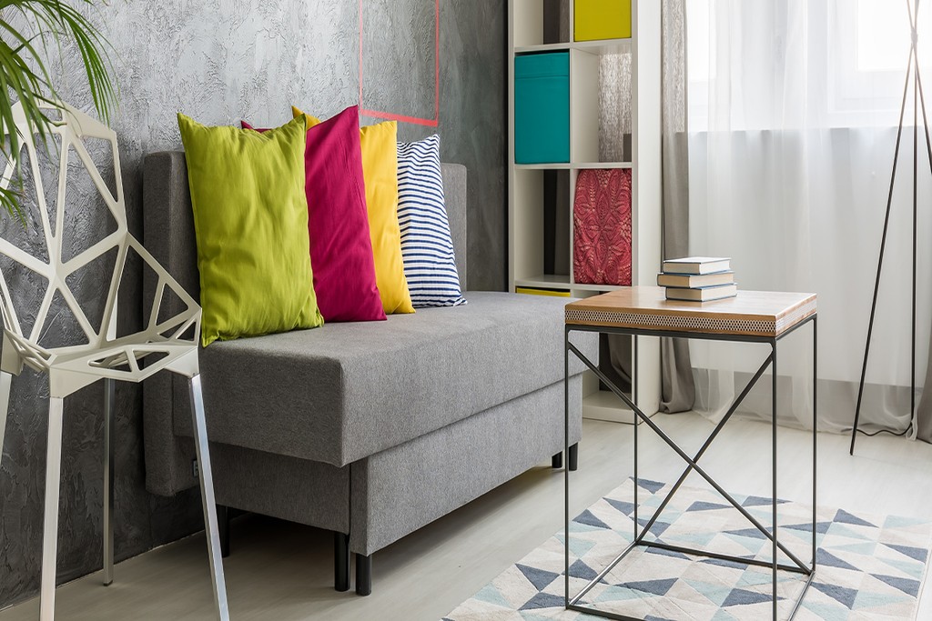 living room with a sofa with coloured pillows and a table