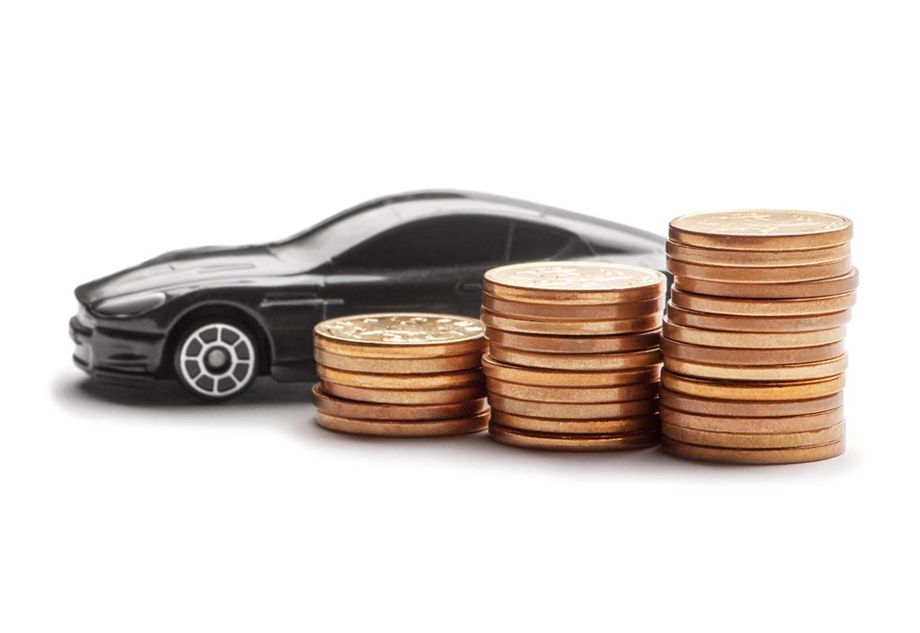 Car model over a lot of money stacked coins on white background