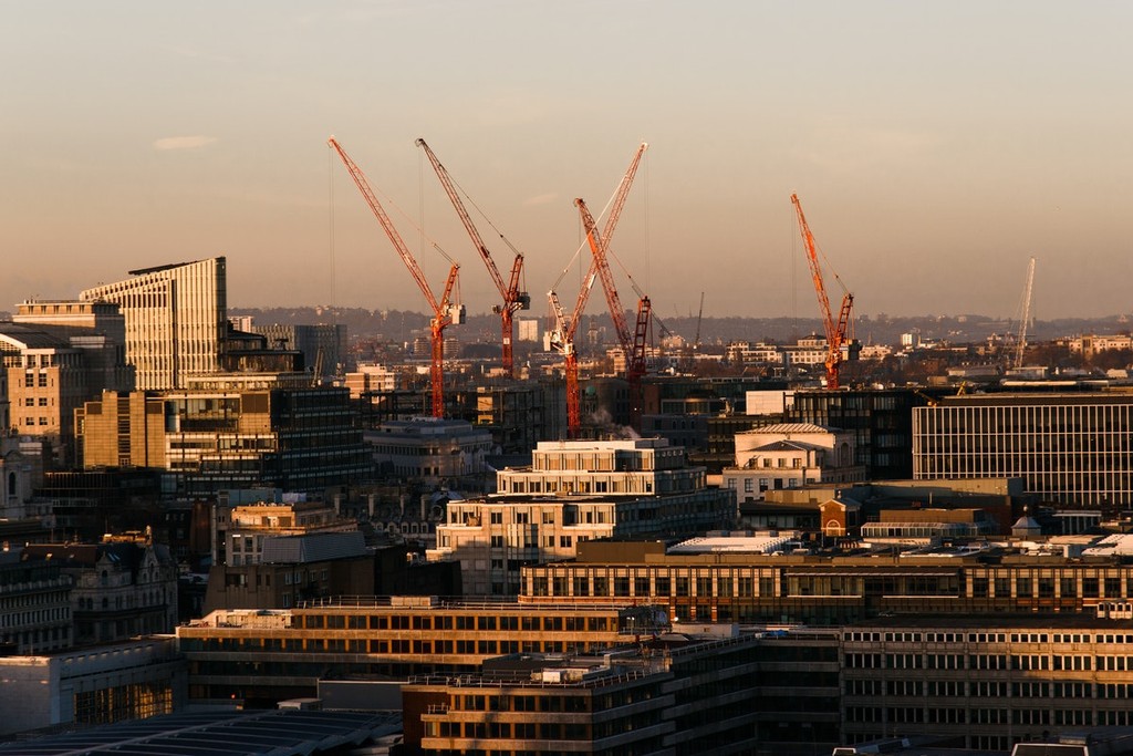 cranes in the sky cityscape against the sunset