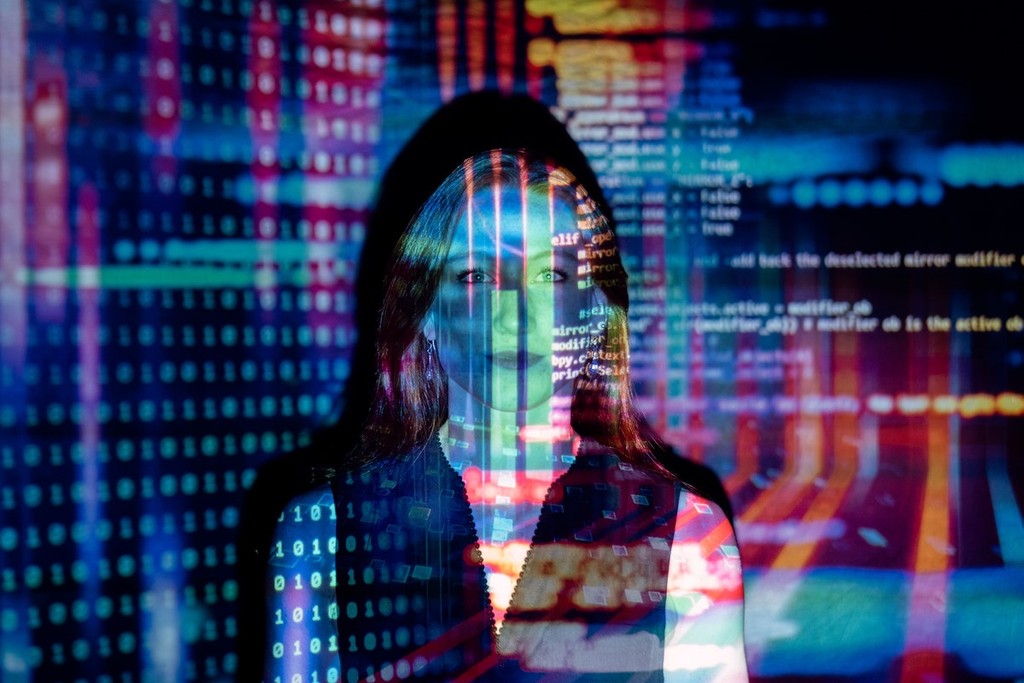 woman with lights reflected on her written in proptech code