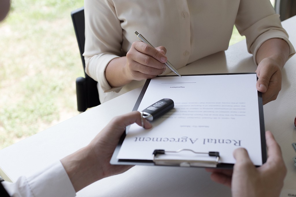 rental agreement being signed by a woman