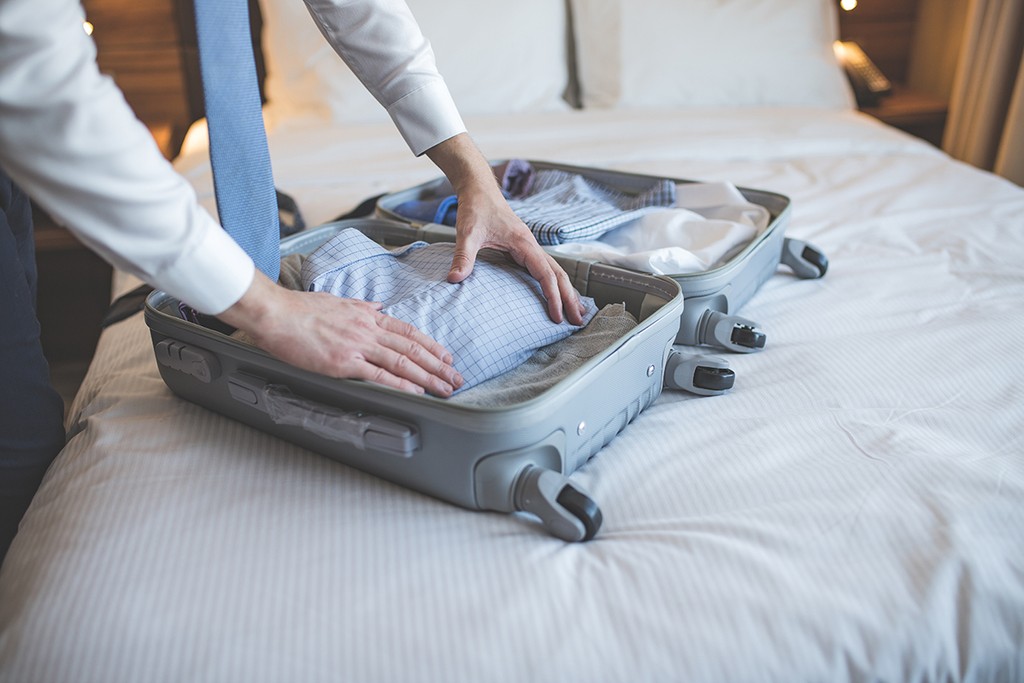 Businessman with a suitcase in the hotel