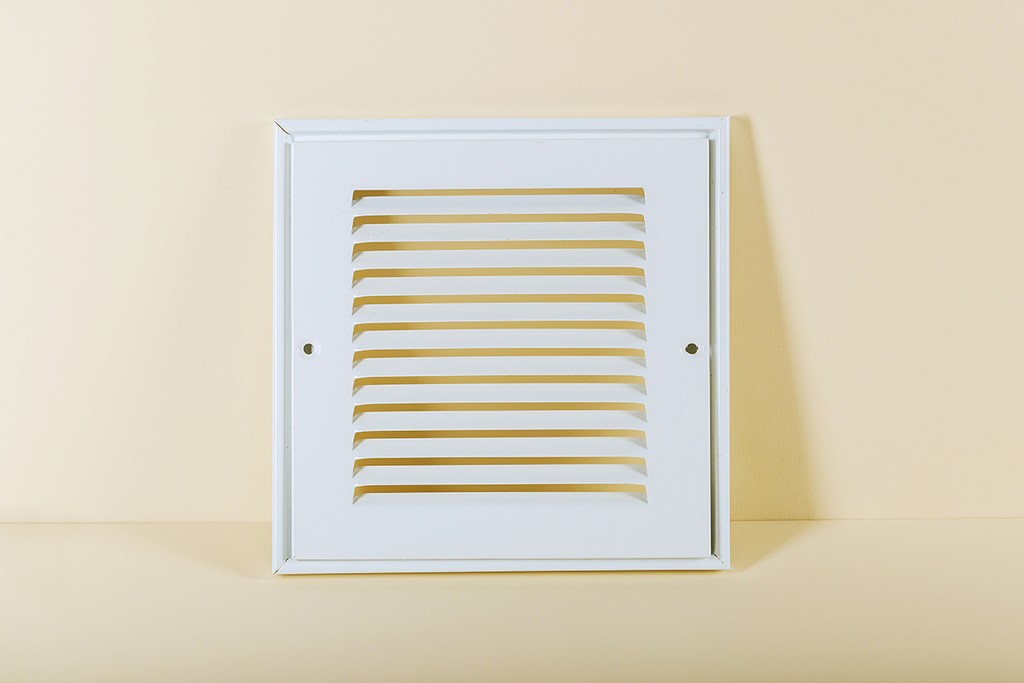 extractor fan laid against a beige wall