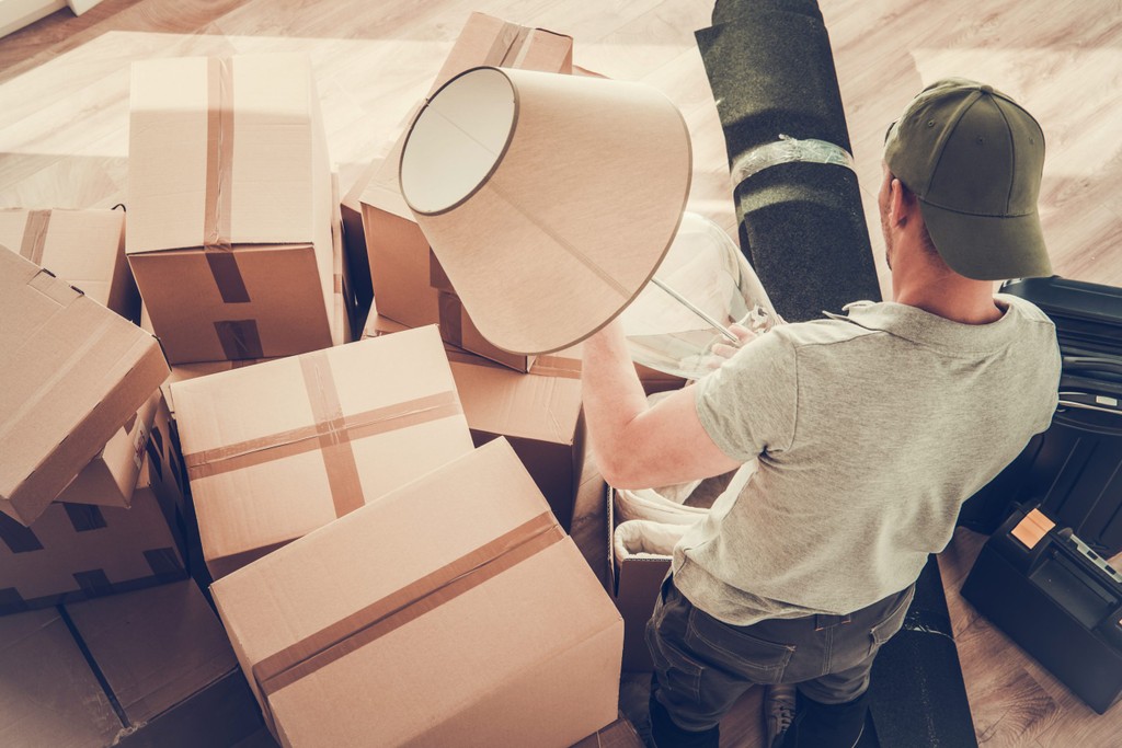 moving out of a home, man packing a lamp