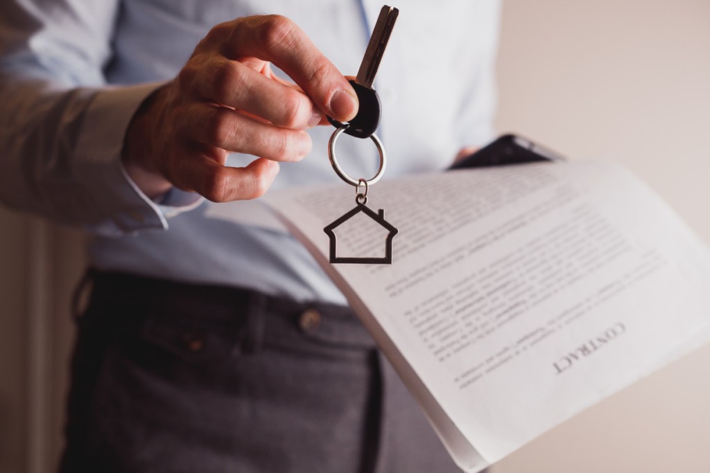 a property manager in london handing keys to tenant