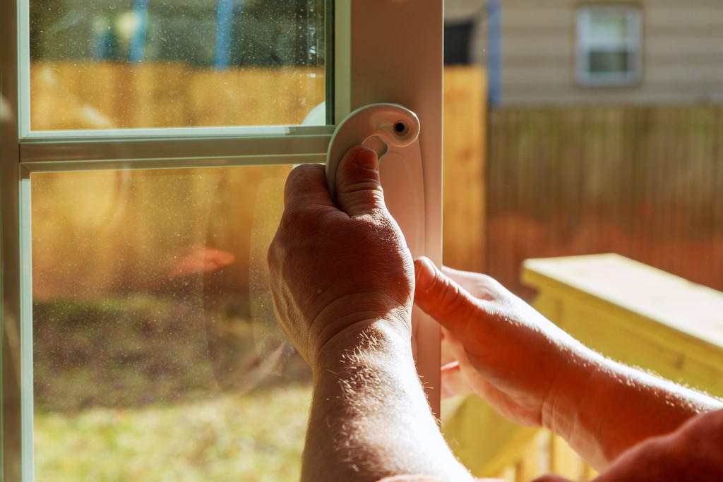 man shutting window at the end of tenancy