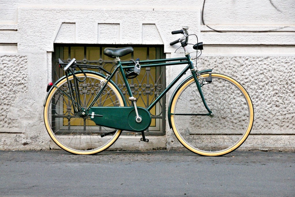 green and beige bicycle in the street